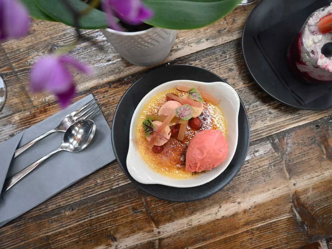 An elegant plated dessert with rhubarb and sorbet at The Duke on the Test, a riverside dining pub near Romsey