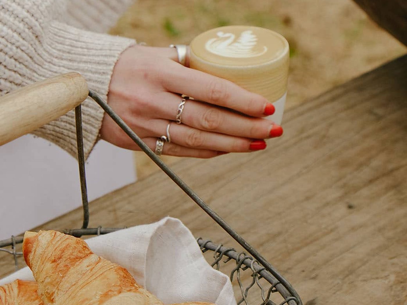 A latte with swan latte art and a basket of fresh croissants at Hampshire Pantry farm shop and cafe