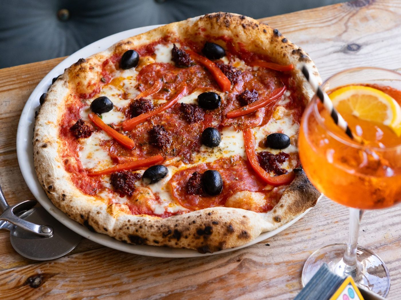 A wood-fired sourdough pizza with an Aperol spritz at Three Joes pizzeria